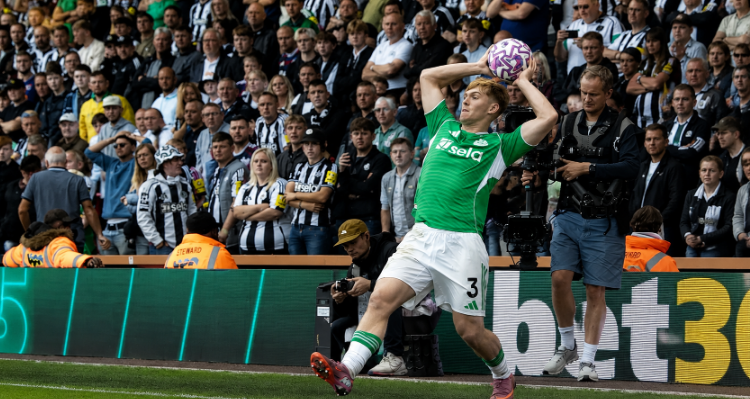 Newcastle United player Lewis Hall performing a long throw-in during a Premier League match